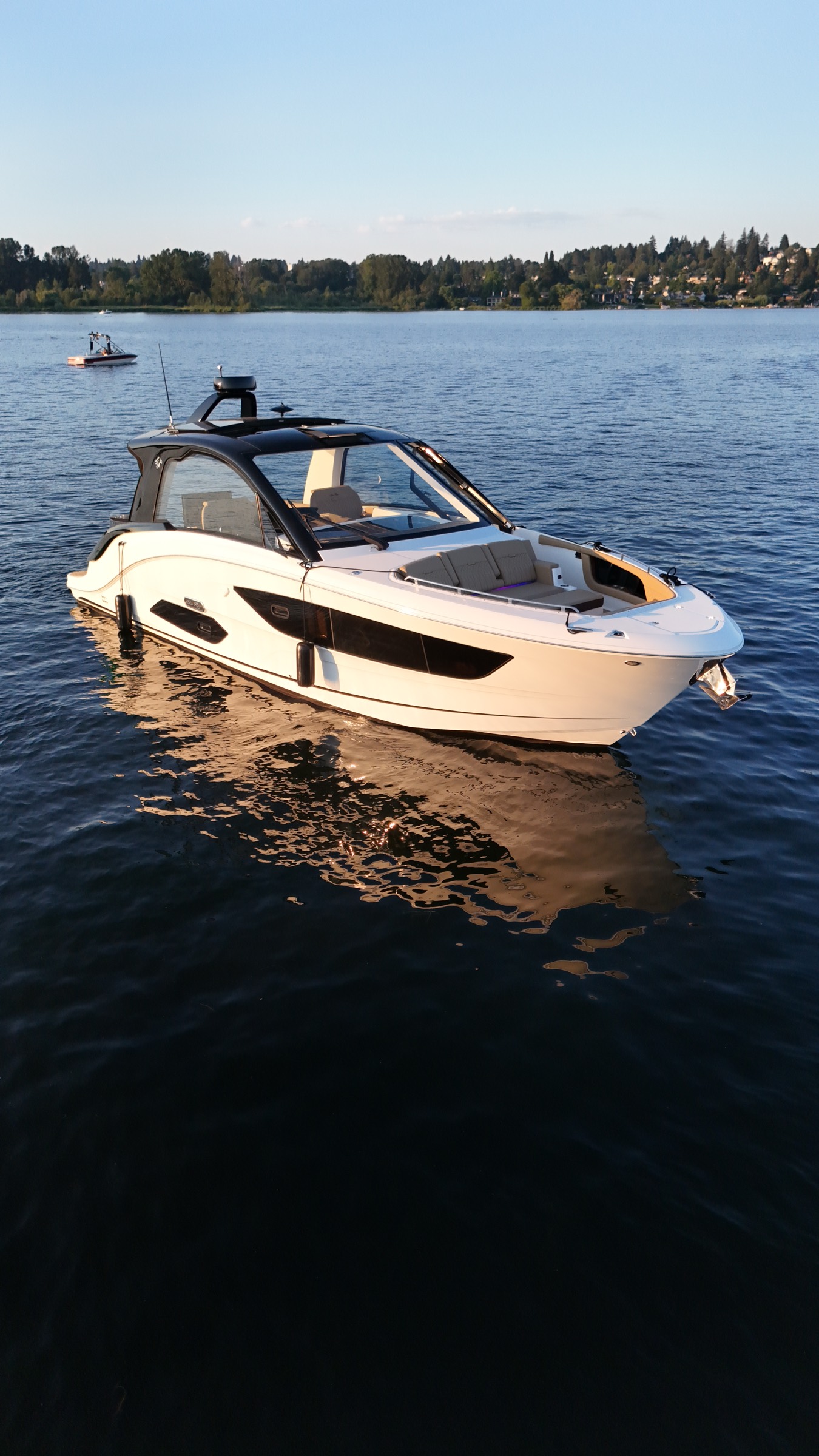 Sea Raptor from the bow quarter on calm water at sunset